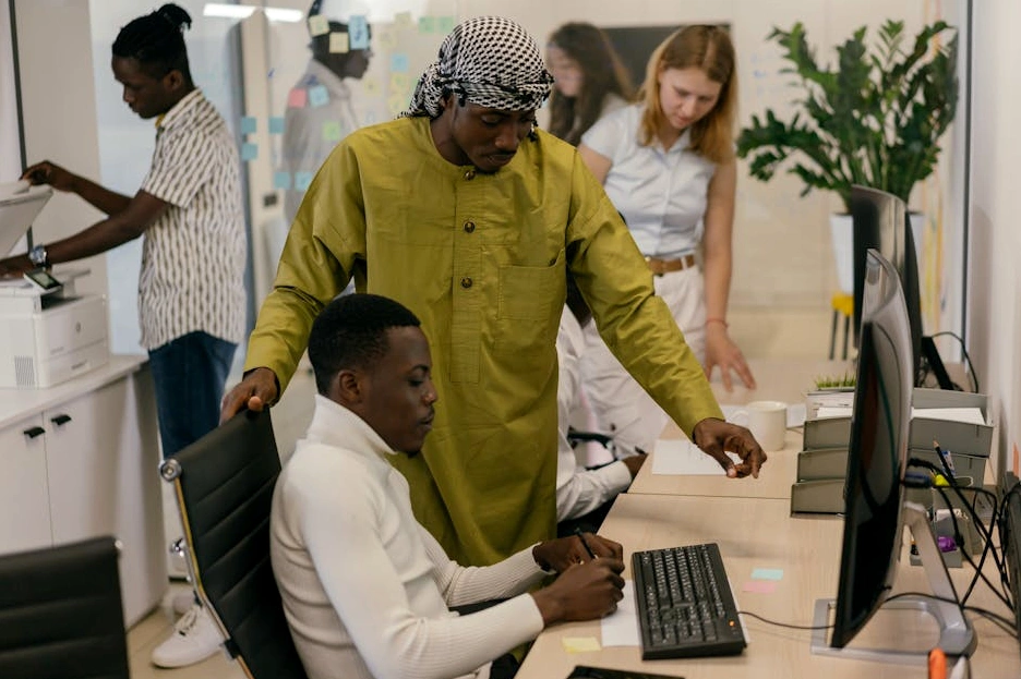 A diverse team of consultants collaborating around a large table with a world map.